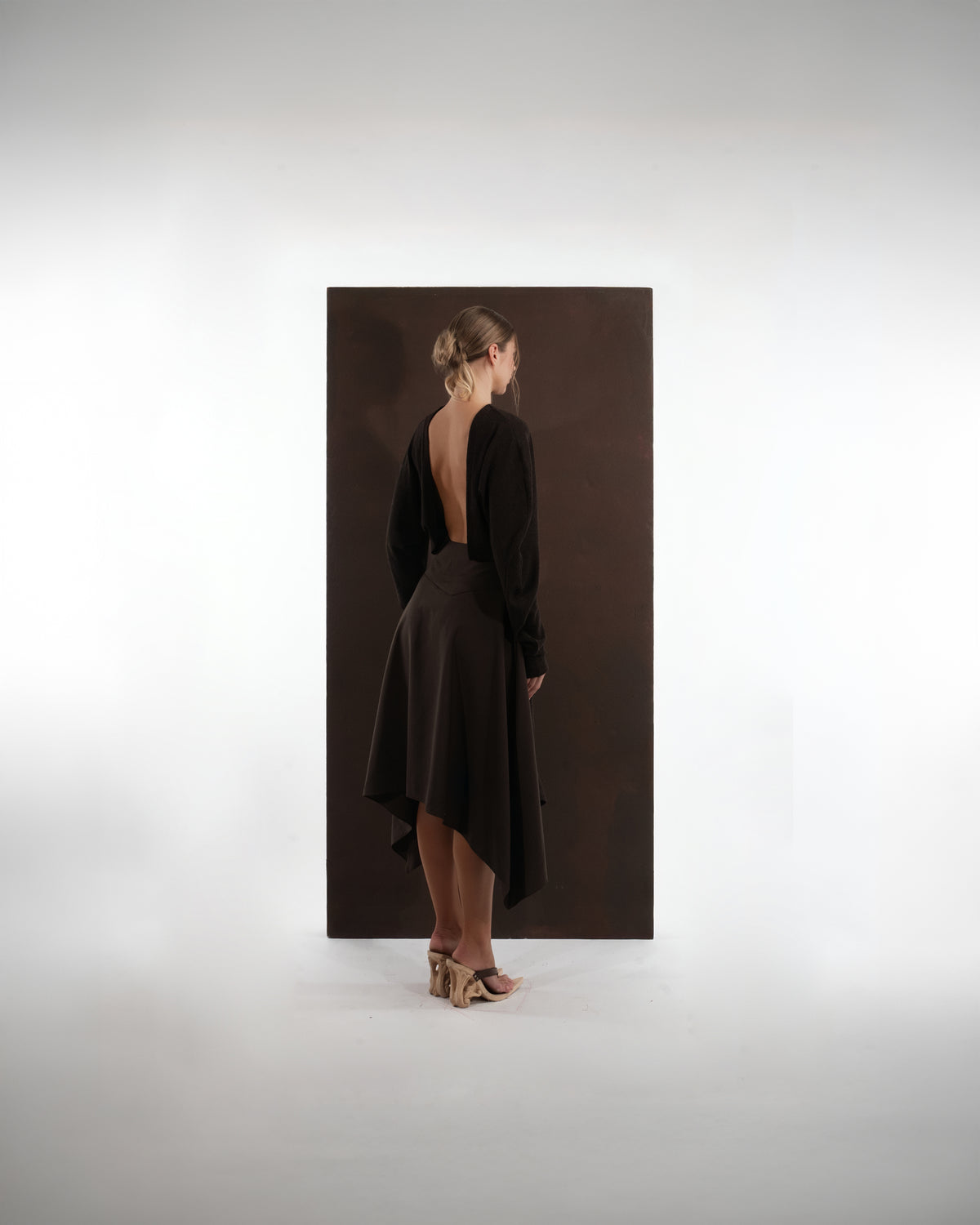 ALISADUDAJ mocha brown wool open-back dress, back view showing deep scooped open back and pointed hem