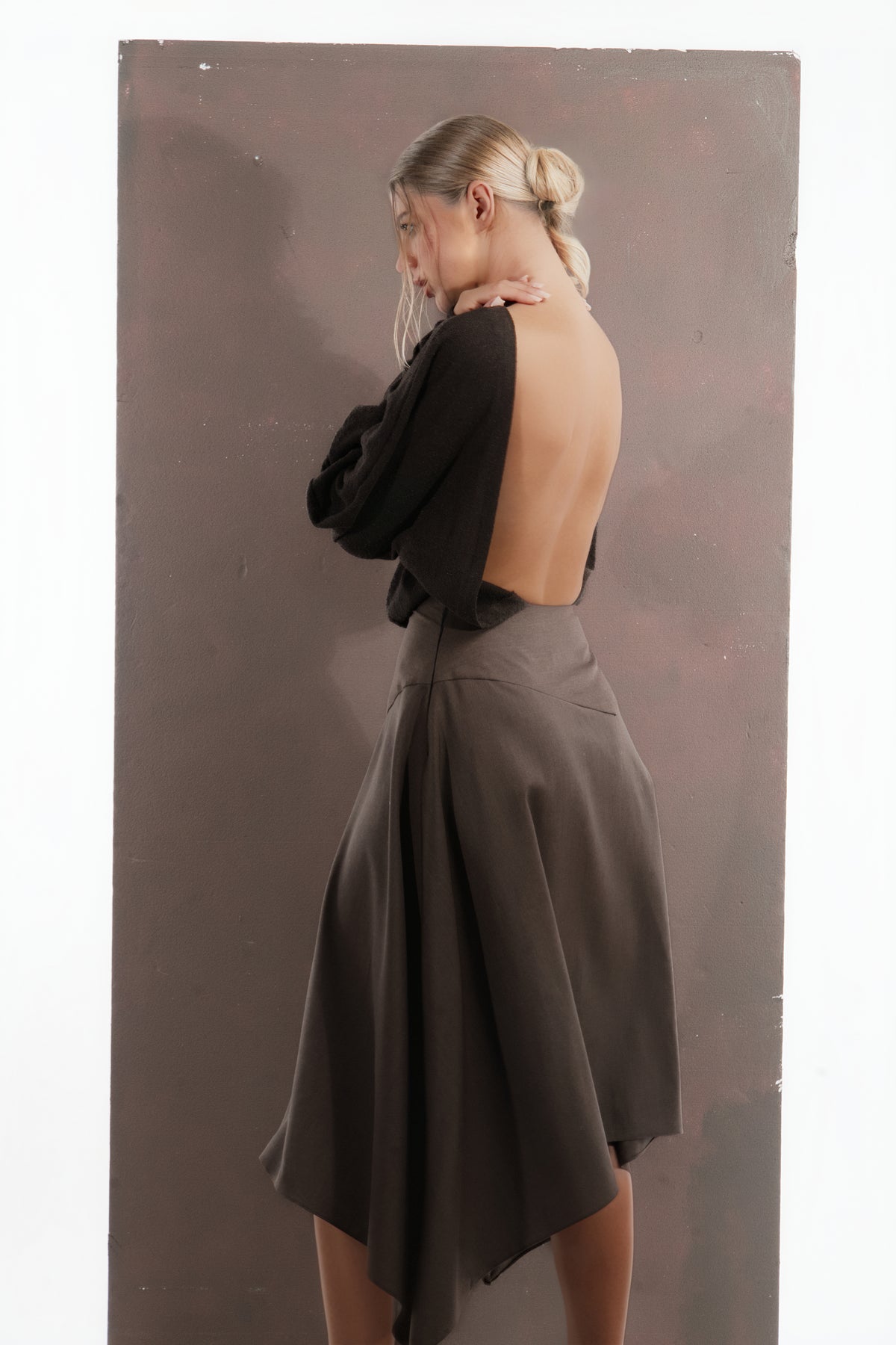 ALISADUDAJ mocha brown wool open-back dress, side back view showing sleeve drape and flared skirt, wool blend