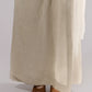 ALISADUDAJ taupe linen wide-leg trousers, close-up of hem and sheer overlay falling over sandals