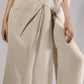 ALISADUDAJ taupe linen wrap trousers, close-up of pleated wrap front and mesh overlay, linen and silk