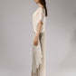ALISADUDAJ taupe linen set with sheer mesh overlay, side profile showing embroidered mesh sleeve and wrap panel