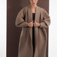 ALISADUDAJ taupe wool oversized coat, front close-up of shawl collar held in both hands, wool blend