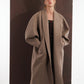 ALISADUDAJ taupe wool oversized coat, front view worn open over an embroidered black dress