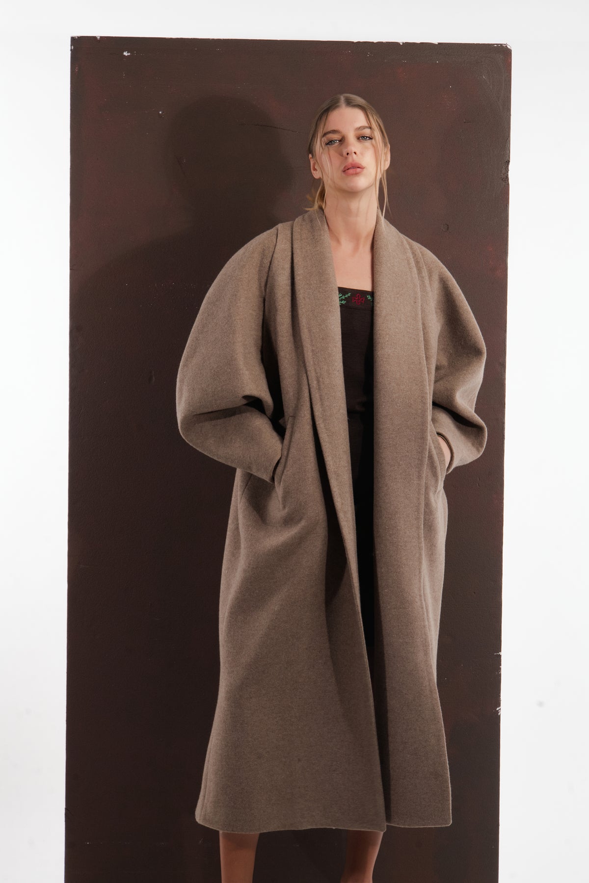 ALISADUDAJ taupe wool oversized coat, front view worn open over an embroidered black dress