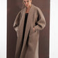 ALISADUDAJ taupe wool oversized coat, three-quarter view with hands in pockets showing coat drape