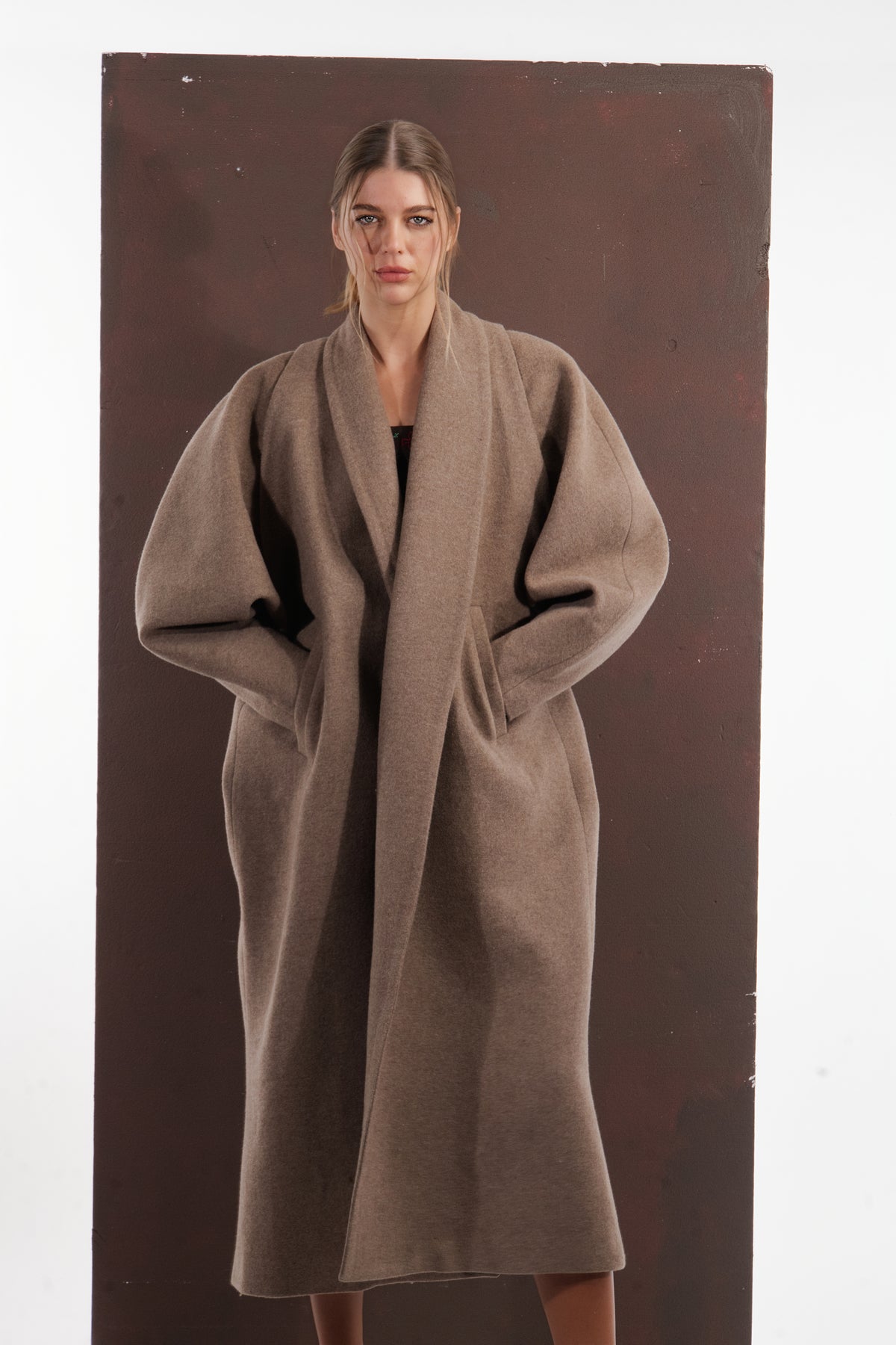 ALISADUDAJ taupe wool oversized coat, front view with hands in pockets showing wide shawl lapels