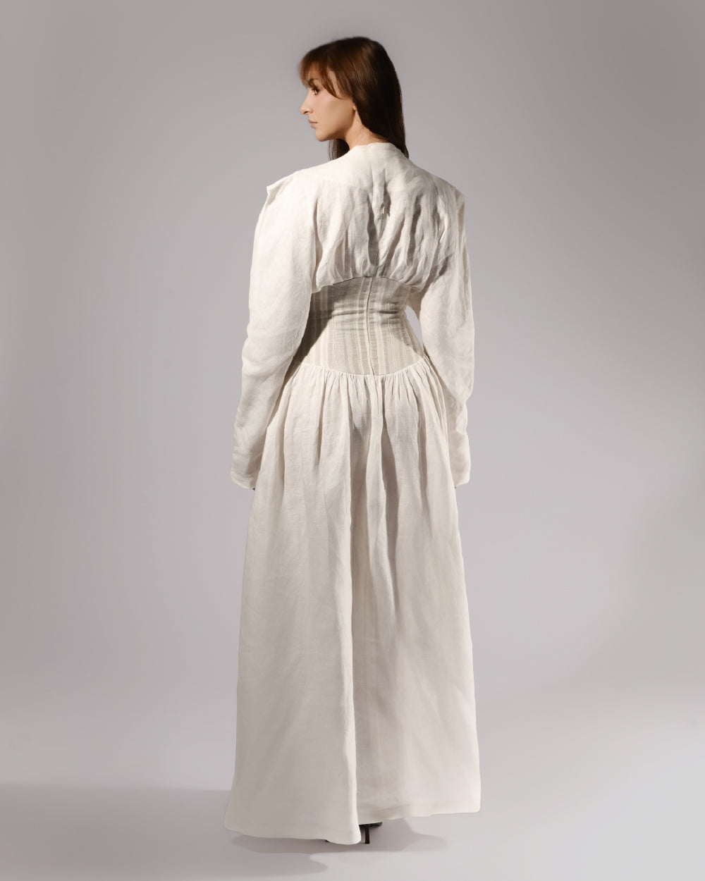 ALISADUDAJ white linen corseted maxi dress, back view showing gathered bodice, corset panel and full skirt