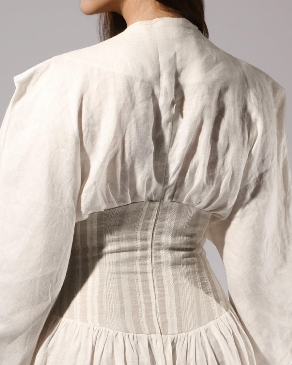 ALISADUDAJ white linen corseted maxi dress, back close-up of pleated bodice and corset waist