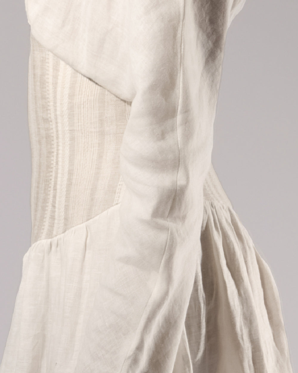 ALISADUDAJ white linen corseted maxi dress, side close-up of sleeve seam and skirt gathers, linen