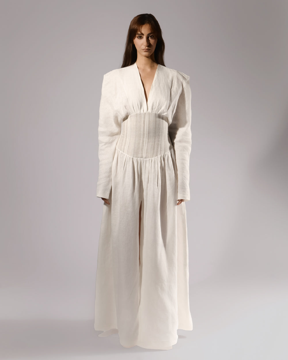 ALISADUDAJ white linen corseted maxi dress, front view, full length, showing deep V neckline, striped corset waist and front slit