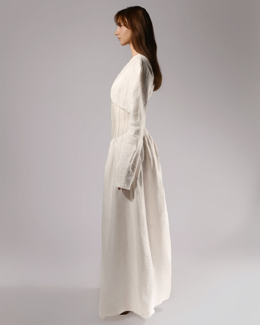 ALISADUDAJ white linen corseted maxi dress, side profile showing structured shoulders and long sleeves