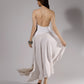 ALISADUDAJ white linen strappy maxi dress, back three-quarter view holding the skirt out to show volume