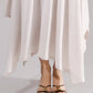 ALISADUDAJ white linen strappy maxi dress, close-up of pointed hem and strappy sandals