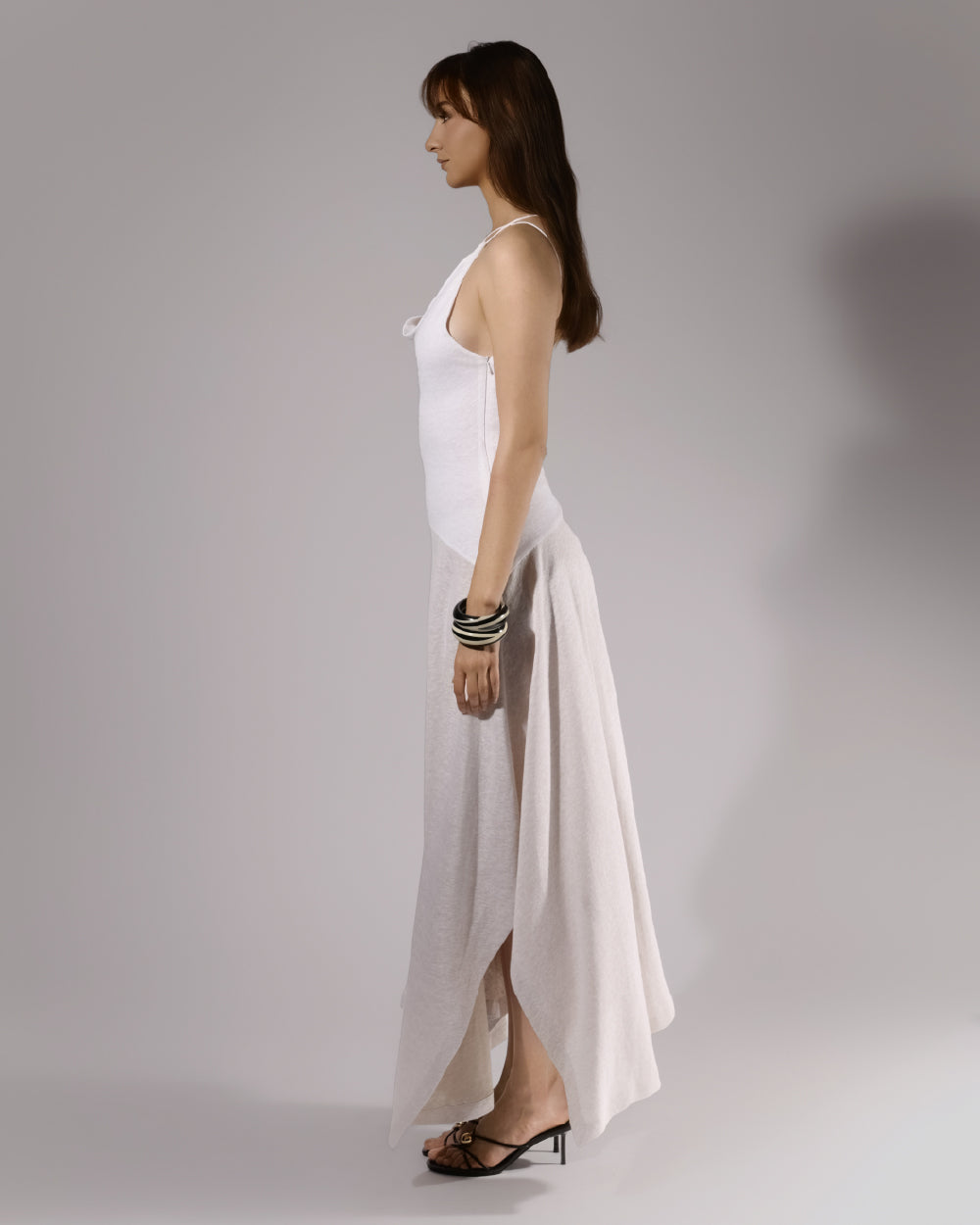 ALISADUDAJ white linen strappy maxi dress, side profile showing fitted bodice and flared skirt