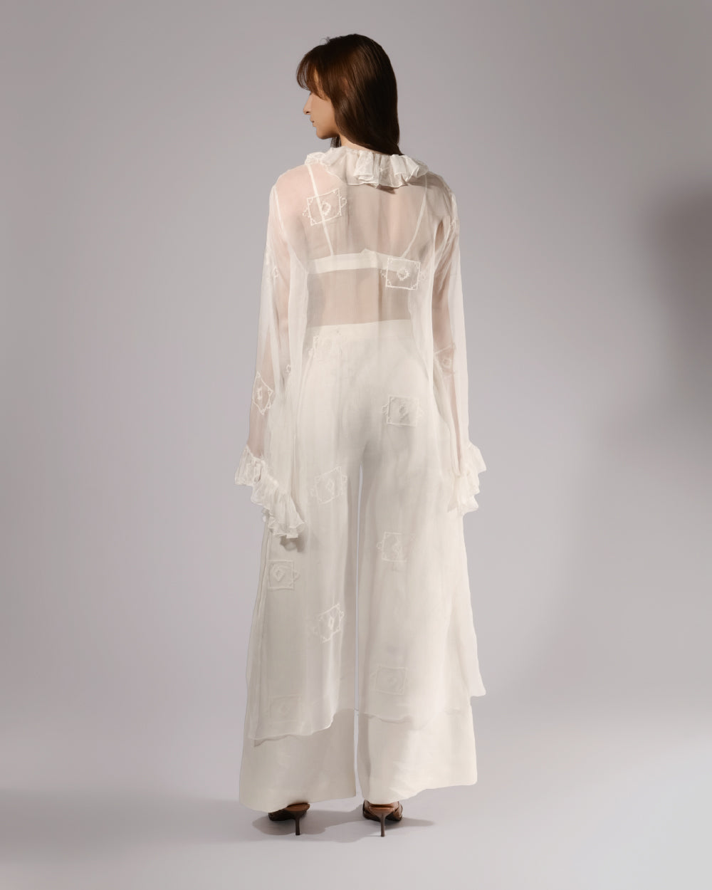 ALISADUDAJ white sheer silk three-piece set, back view showing embroidered motifs on the sheer duster